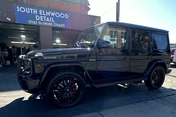 car is parked outside a building with a sign that reads "SOUTH ELMWOOD DETAIL."